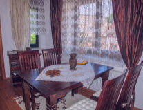 a dining room table in front of a curtain
